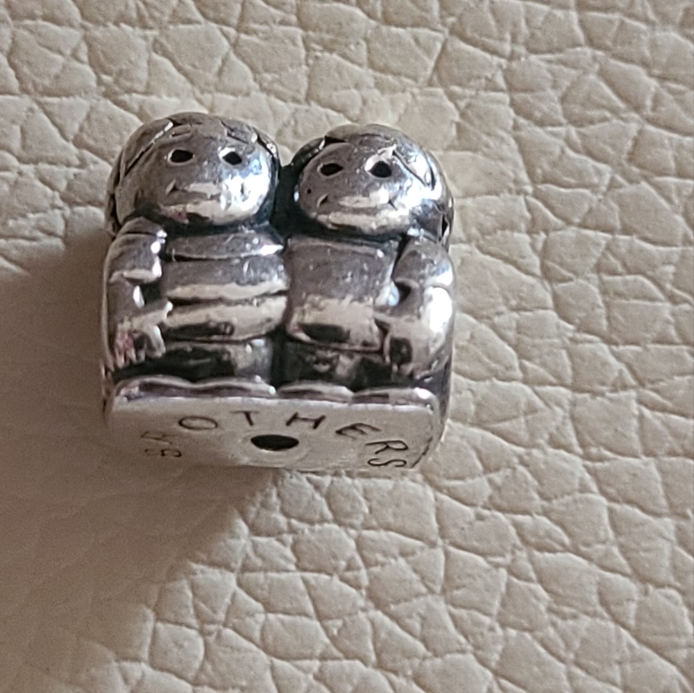 Authentic Chamilia brothers charm.